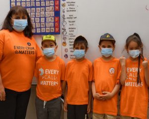 Wiikwemkoong students and teacher wearing orange shirts in recognition of Every Child Matters.